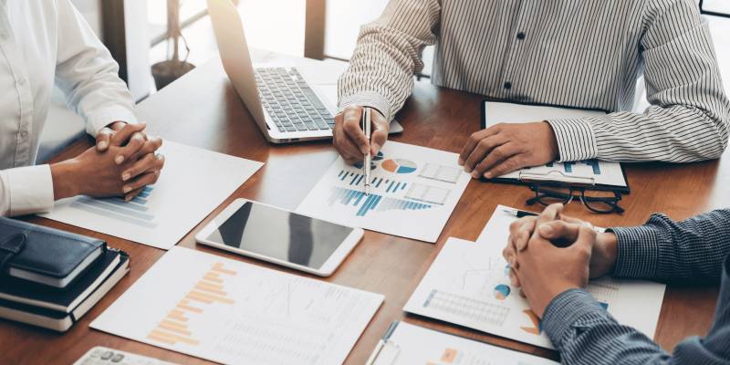 One man is discussing on a topic and two man listening to him