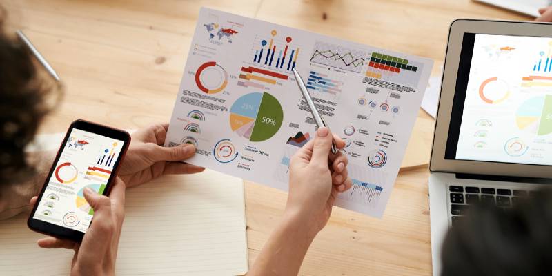 Man is measuring something in laptop and mobile in hand