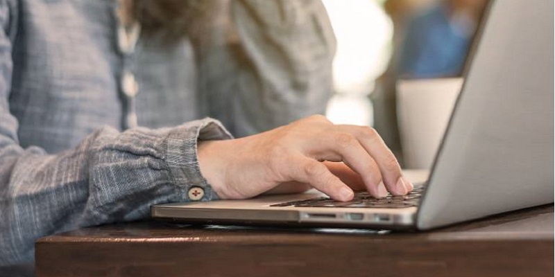Woman is typing something on her laptop
