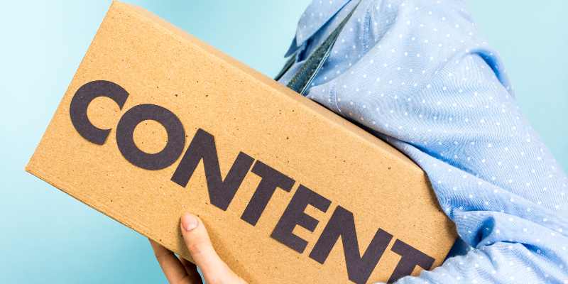 A man holding a box and content is written on the box.